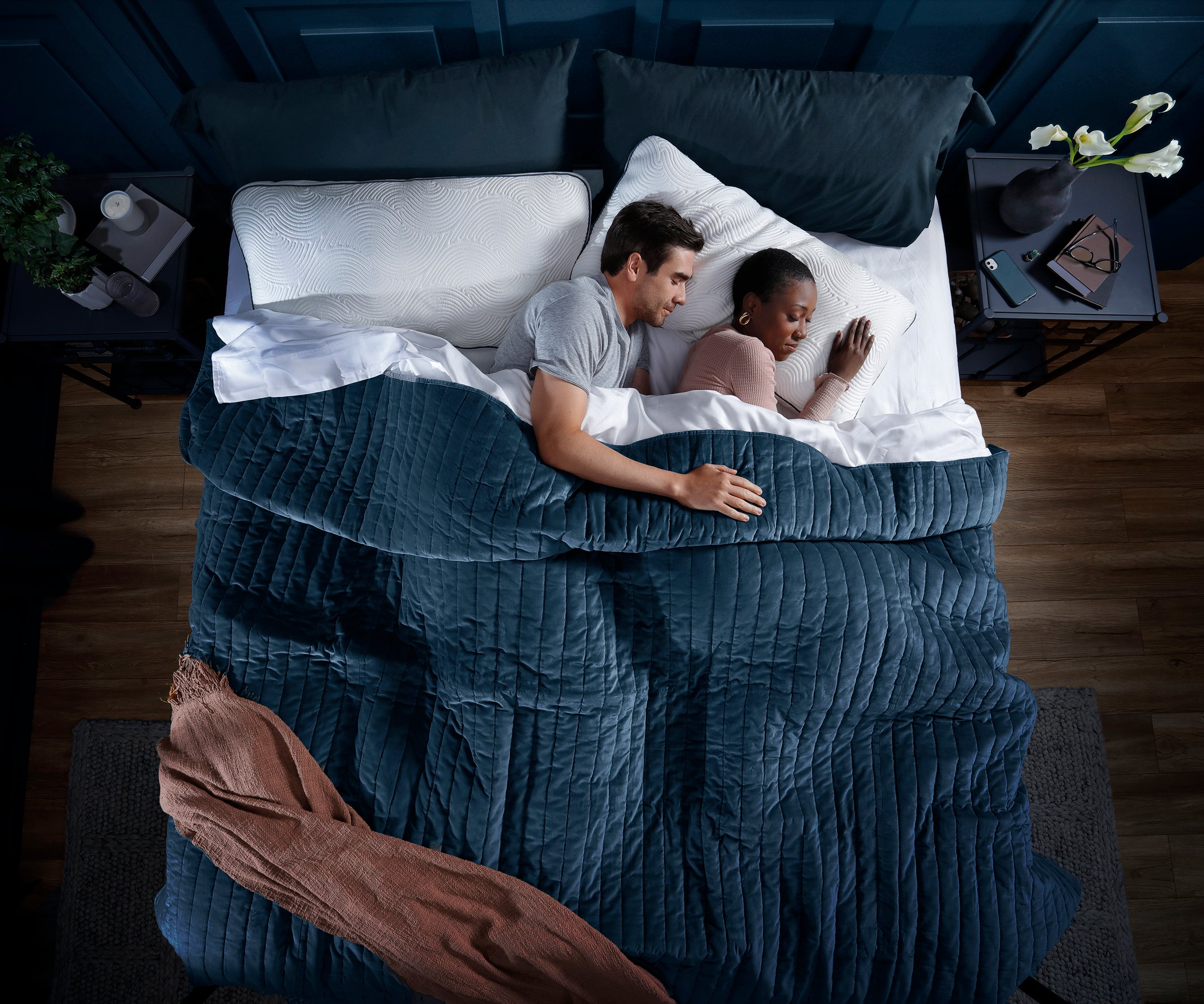 Diverse couple sleeping in dark room on luxury Parallel Pillows