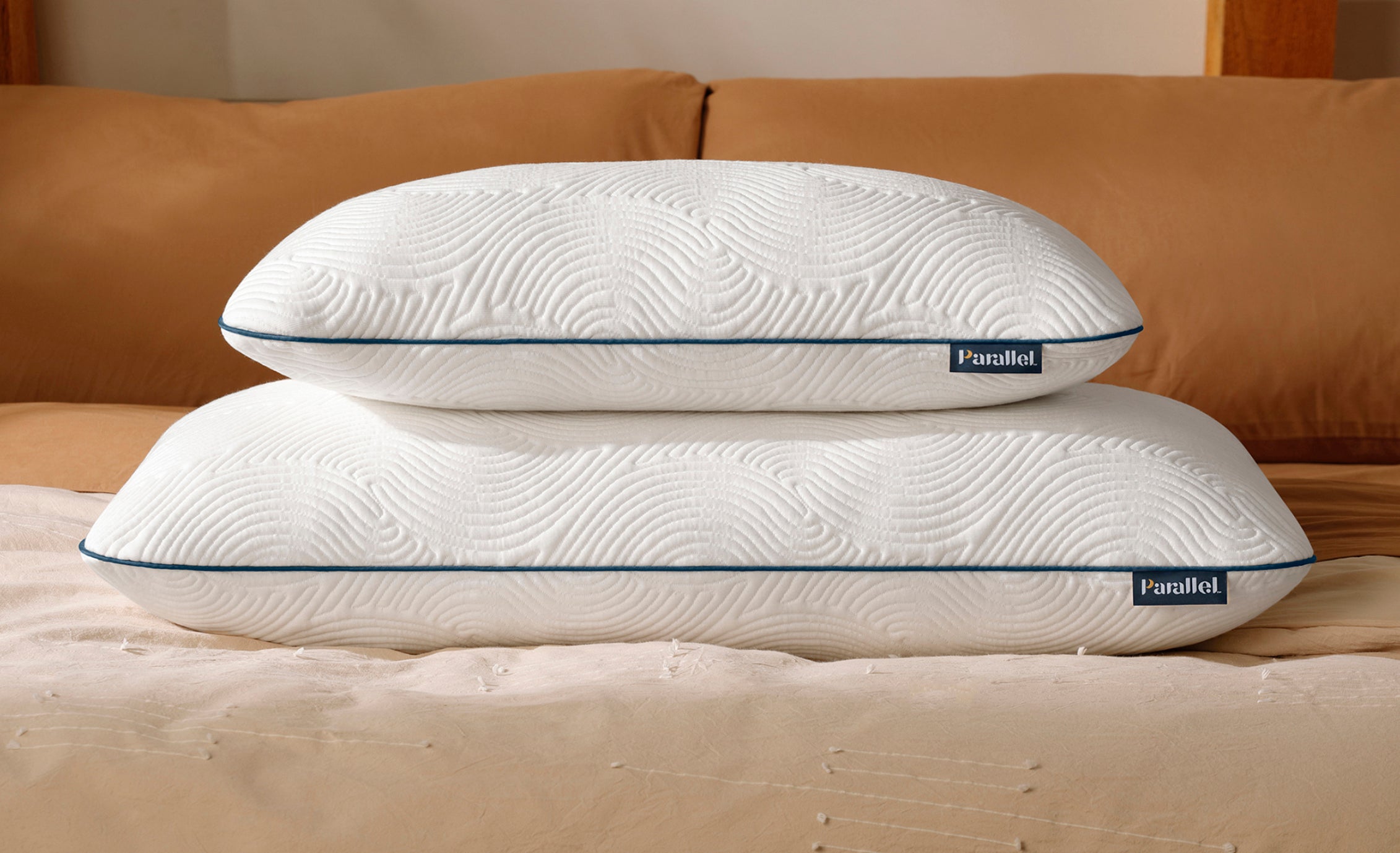 2 low profile high-end pillows stacked on stylish bed