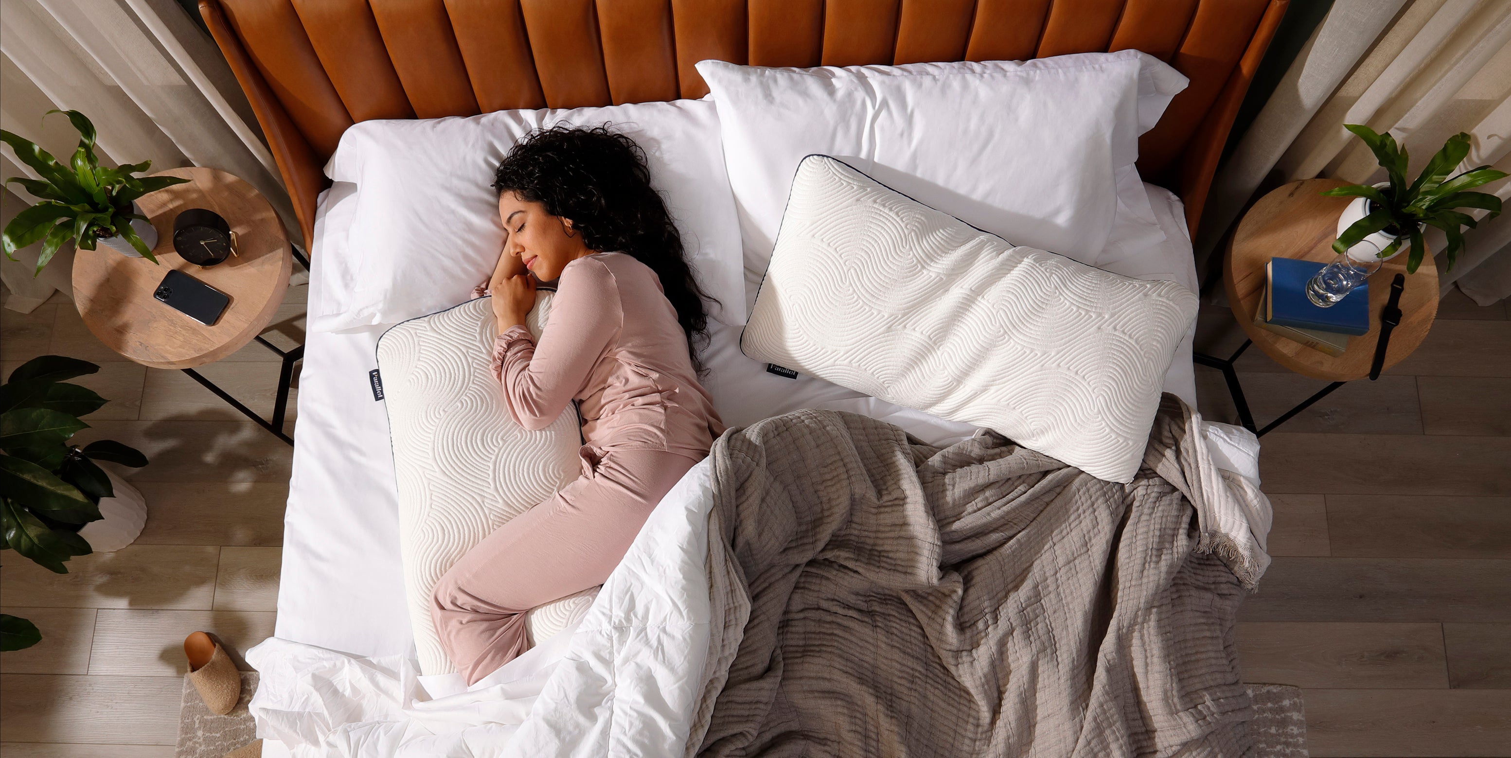 Hispanic woman sleeping in morning light with Parallel Pillow between knees