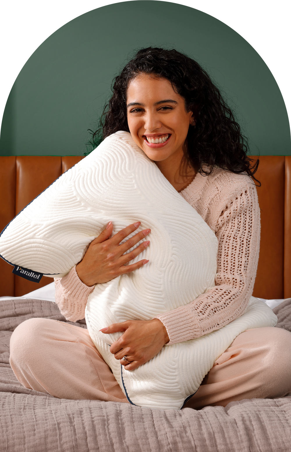 Hispanic woman smiling and hugging ultra-soft Parallel Pillow in bed