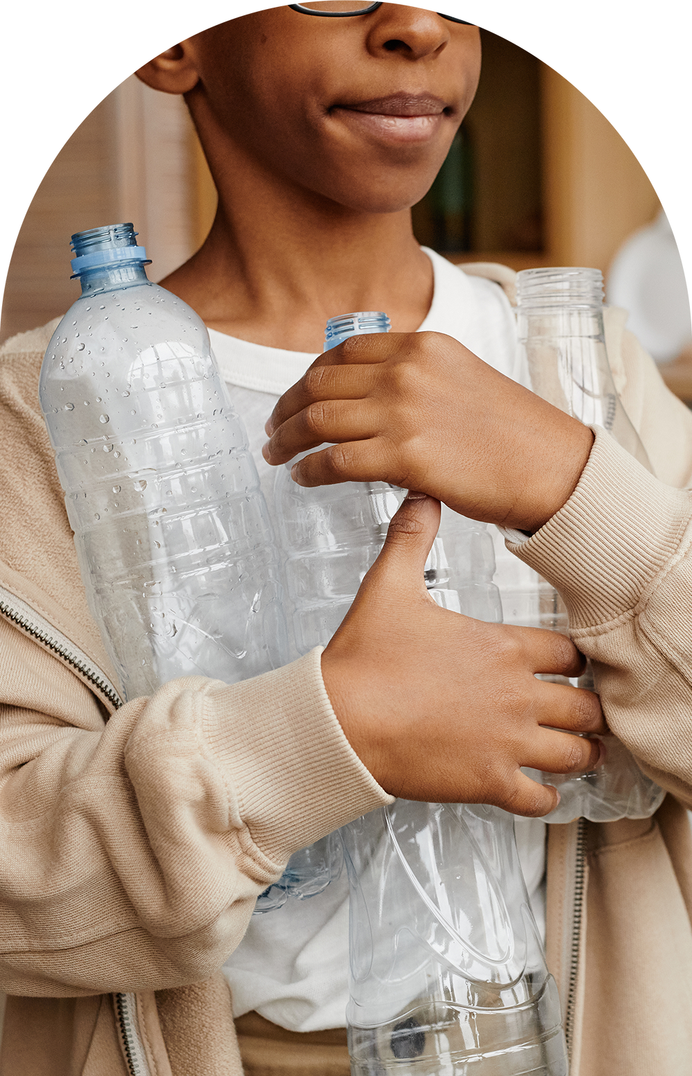 Boy holding plastic bottles to be recycled into sustainable Parallel pillows