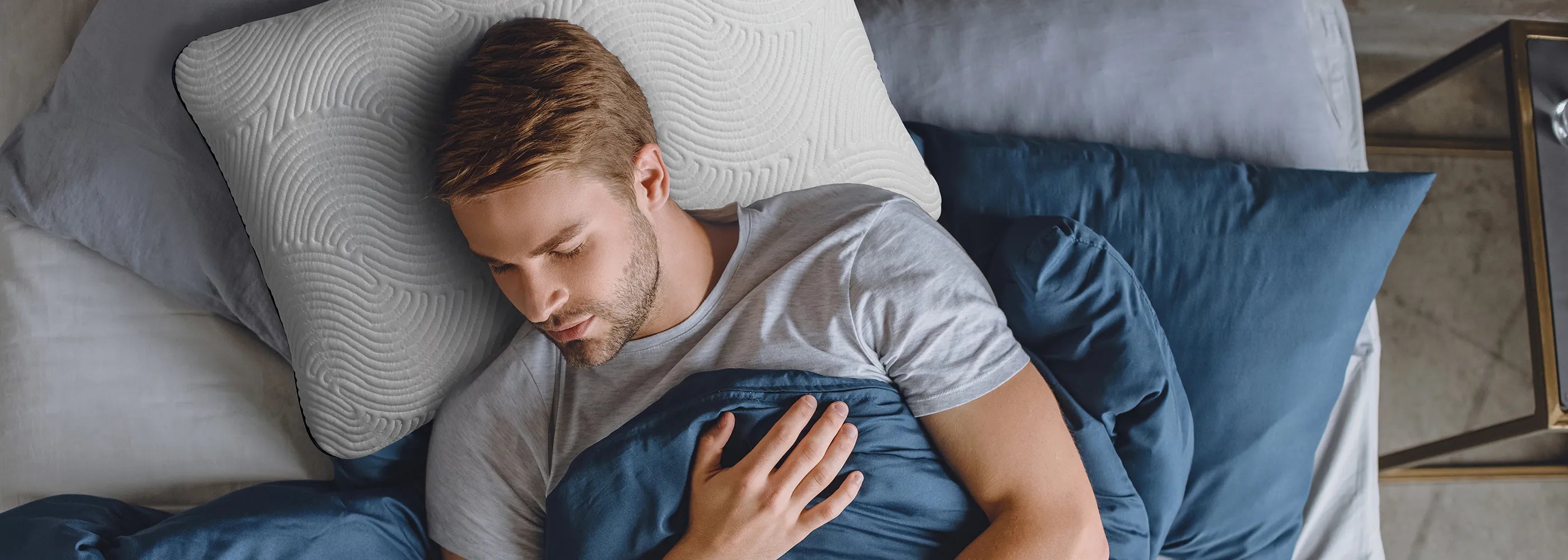 Man sleeping in bed on Parallel Pillow