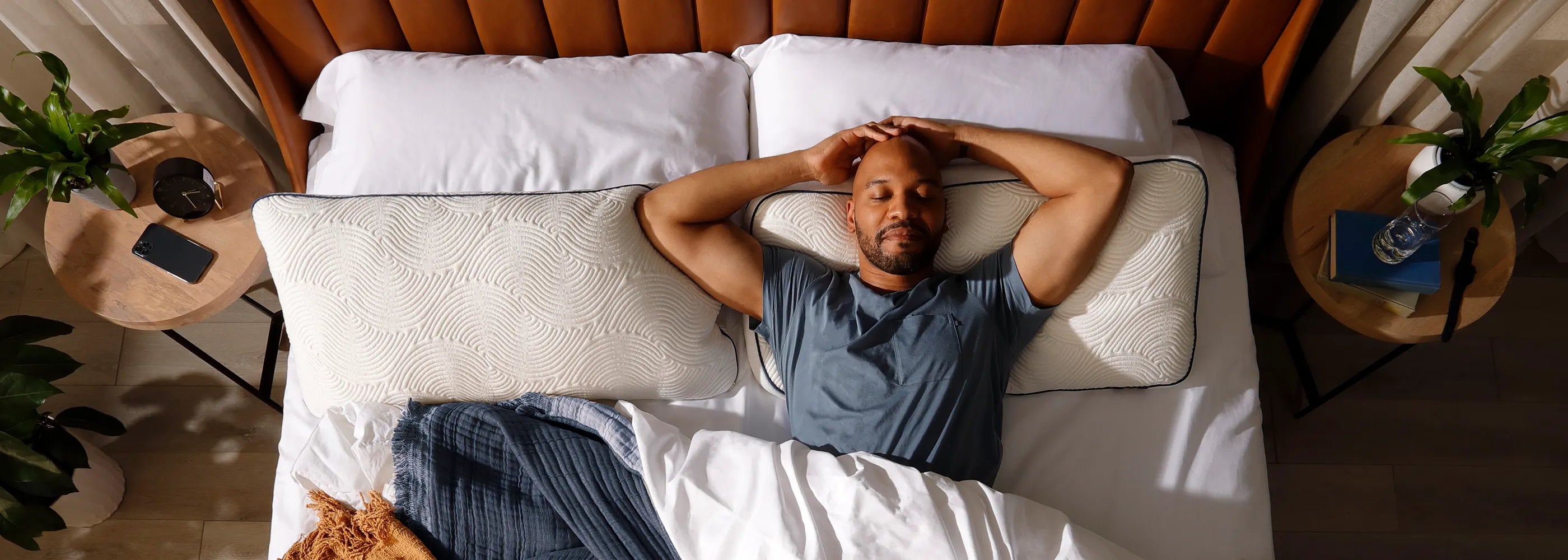 Man relaxed in bed on Parallel Pillow